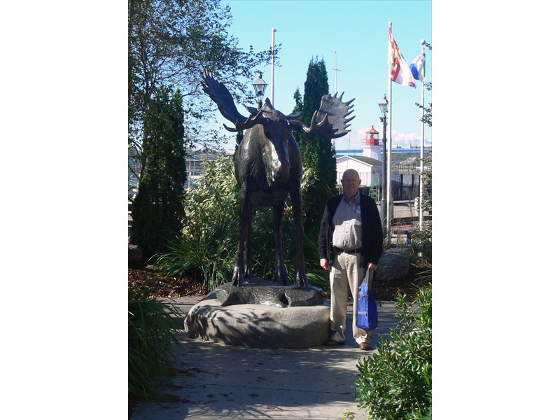 Pete stands next to a moose statue